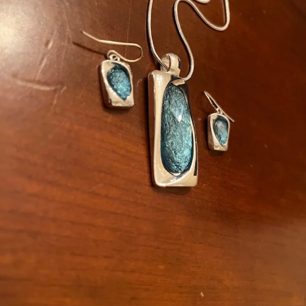 Aqua blue glass pendant and silver tone chain with matching earrings